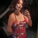 Mia wearing a red dress in a close-up selfie